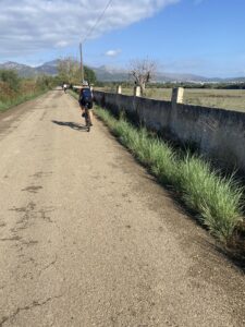 Lone person cycling along road